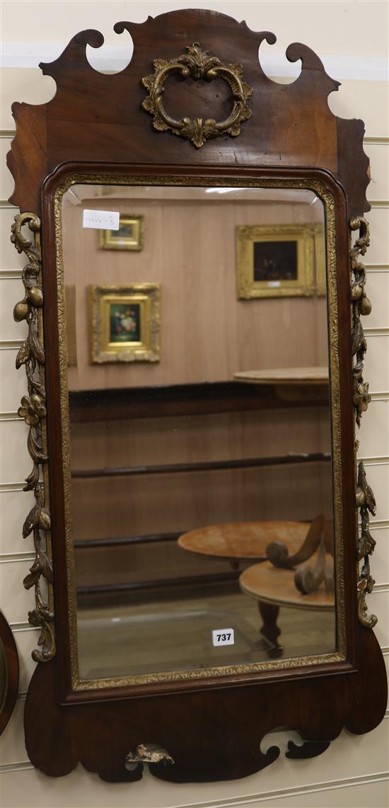 A George III mahogany and parcel-gilt wall mirror having bevelled rectangular plate W.56cm